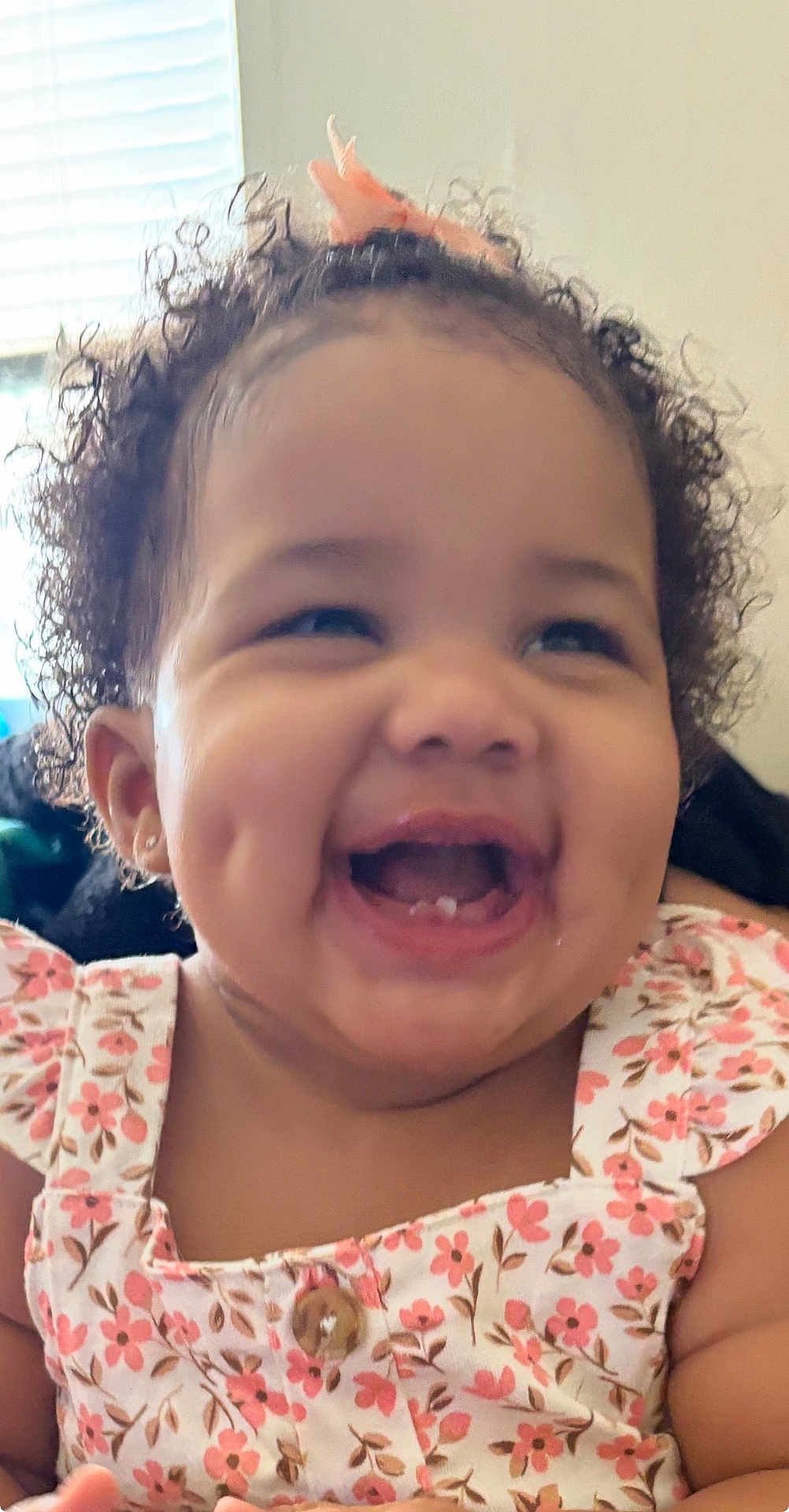Anjayah is registered to the contest to win money with this photo: toddler, child, smiling, curly_hair, floral_dress, indoor, happy, dimples, face, cute, person, baby, portrait, joy, closeup, skin, mouth, teeth, earrings, hair_accessory