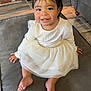 Chantelle joined the competition — help win amazing prizes! toddler, child, smile, white_dress, sitting, indoor, flooring, cushion, furniture, brick_wall, happy, cute, portrait, baby, person, long_sleeves, hair_bow, barefoot, home, young_child