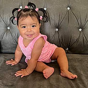Chantelle is registered to the contest to win money with this photo: baby, child, smiling, pigtails, pink_clothing, sofa, couch, indoor, happy, cute, toddler, hair_clips, face, skin, person, sitting, furniture, plush, portrait, young