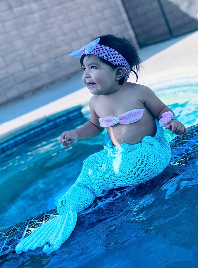 Chantelle is registered to the contest to win money with this photo: baby, child, pool, water, mermaid_costume, headband, smiling, sitting, cute, outdoor, swimming_pool, blue, playful, happy, costume, young_child, fashion, summer, fun, portrait