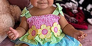 Chantelle joined the competition — help win amazing prizes! baby, bed, blanket, child, colorful_clothing, cute, dress, flower_pattern, foot, hand, happy, indoors, infant, pony_tail, portrait, room, sitting, skin, smiling, soft_toys