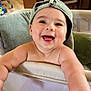 Noah joined the competition — help win amazing prizes! baby, smiling, cap, indoor, playpen, arms, happy, child, face, infant, cute, person, cheerful, skin, headwear, toddler, furniture, pillow, home, expression