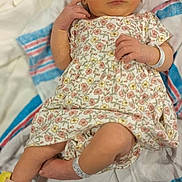 Serenity joined the competition — help win amazing prizes! newborn, baby, infant, floral_dress, headband, blanket, hospital_band, lying_down, cute, small_hands, small_feet, soft_texture, striped_blanket, indoors, portrait, human, skin, sleepy, adorable, child