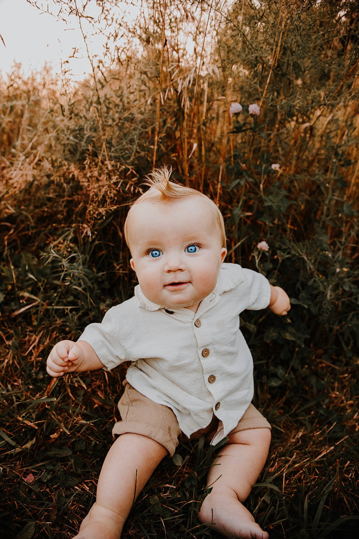 Jay is registered to the contest to win money with this photo: baby, baby_toddler_clothing, blond, cheek, child, eye, face, facial_expression, fawn, flash_photography, grass, happy, iris, people_in_nature, person, plant, skin, standing, sunlight, toddler