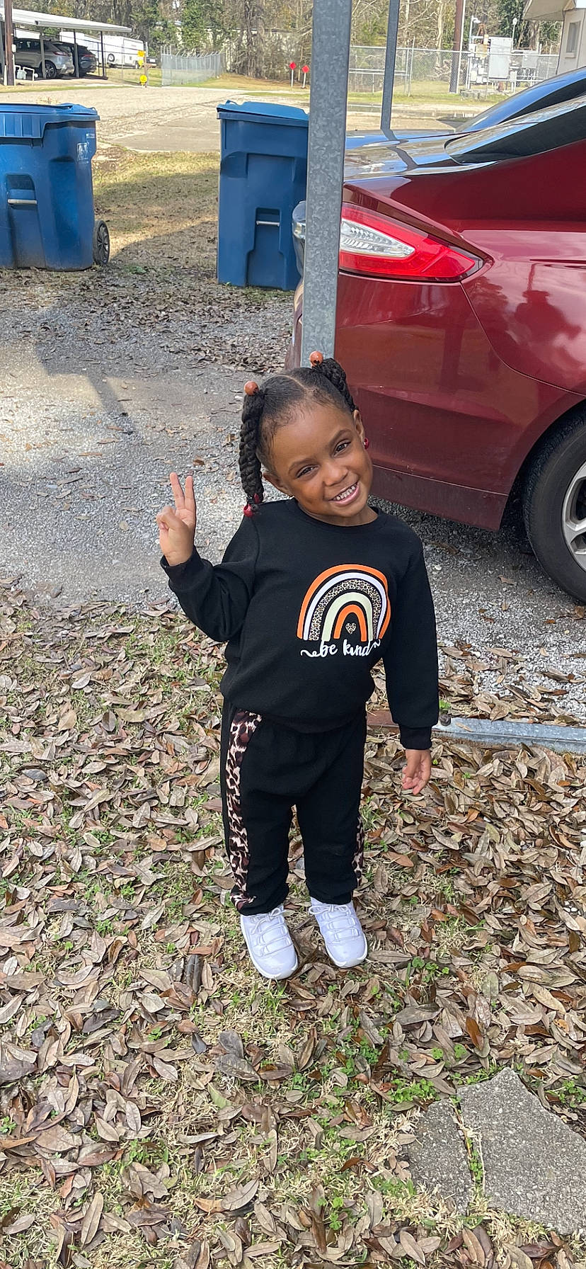 Rory joined the competition — help win amazing prizes! asphalt, automotive_design, automotive_exterior, automotive_lighting, automotive_tire, bumper, car, face, family_car, happy, joy, motor_vehicle, person, rim, sleeve, smile, soil, t_shirt, tire, toddler