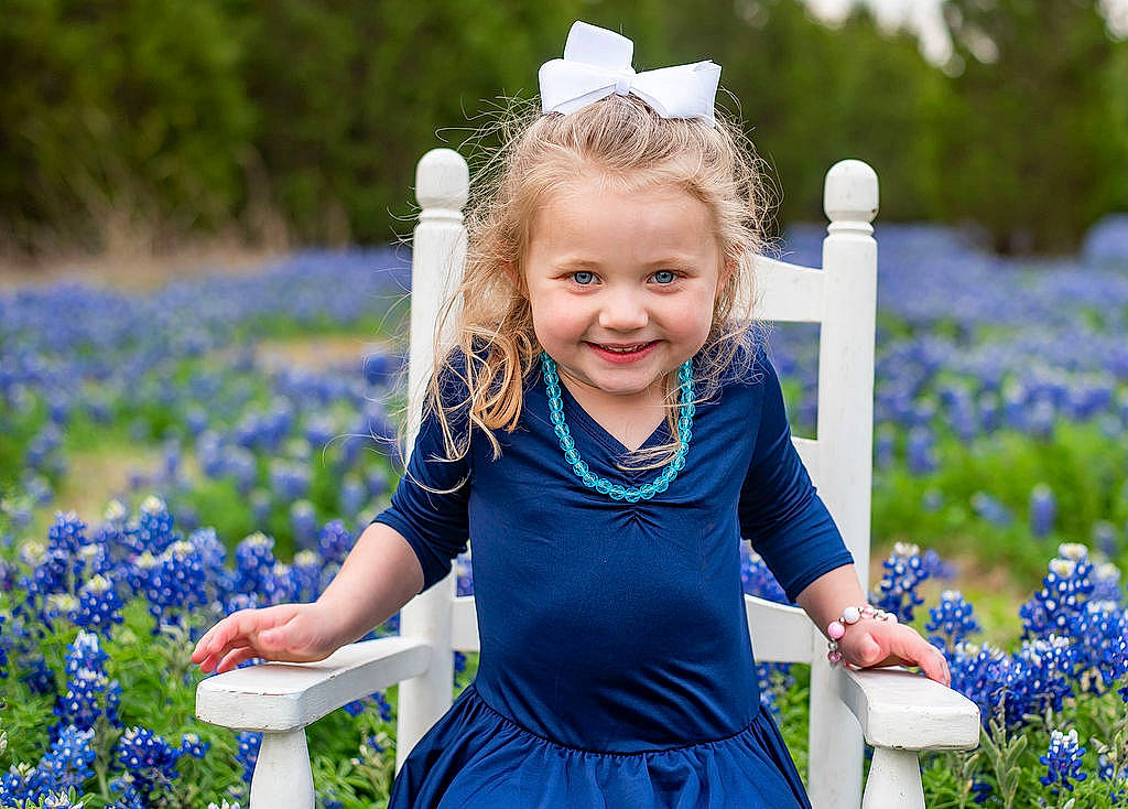 Kenzington is registered to the contest to win money with this photo: annual_plant, blond, blue, child, electric_blue, eye, face, flower, grass, happy, iris, joy, meadow, people_in_nature, person, photograph, plant, purple, smile, summer