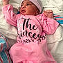 newborn, baby, pink_clothing, hat, blanket, hospital_blanket, infant, face, person, lying_down, sleepwear, cute, small_hands, portrait, indoors, soft_fabric, resting, newborn_baby, child, cozy