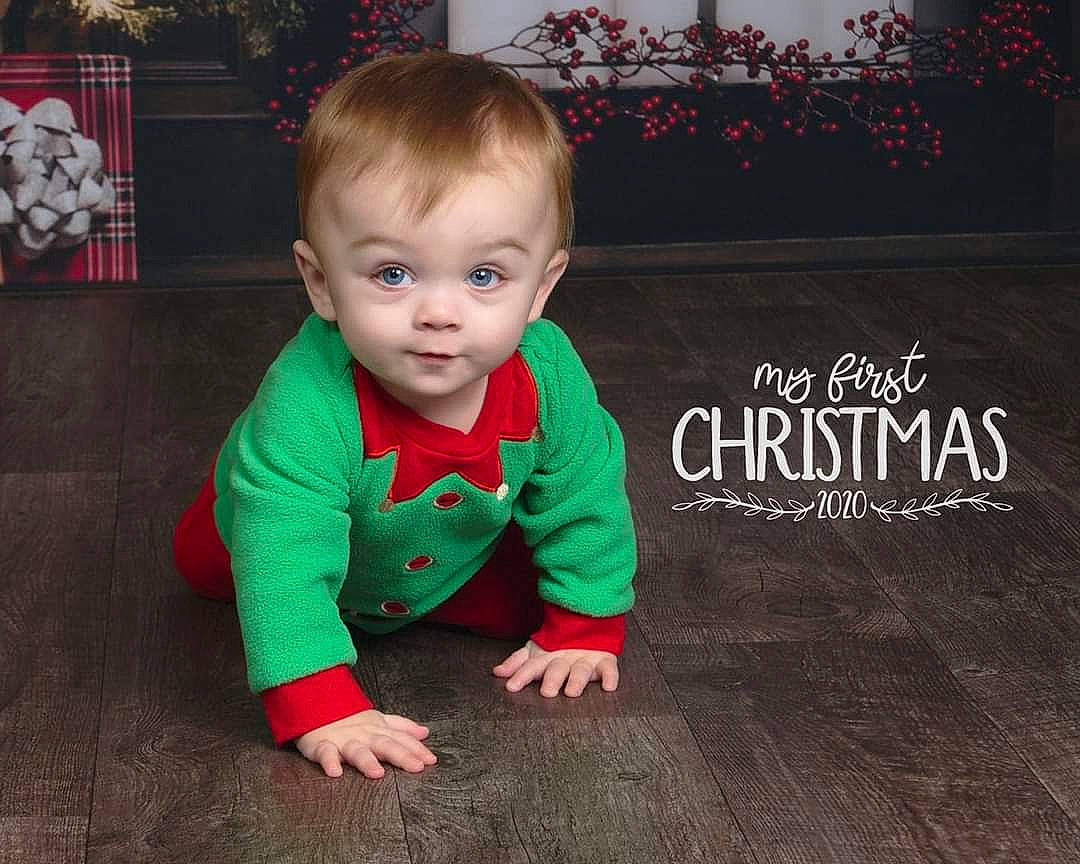 Kristian is registered to the contest to win money with this photo: baby, baby_toddler_clothing, cheek, child, crawling, flash_photography, floor, flooring, font, grass, happy, hardwood, pattern, person, plant, product, skin, sleeve, smile, toddler