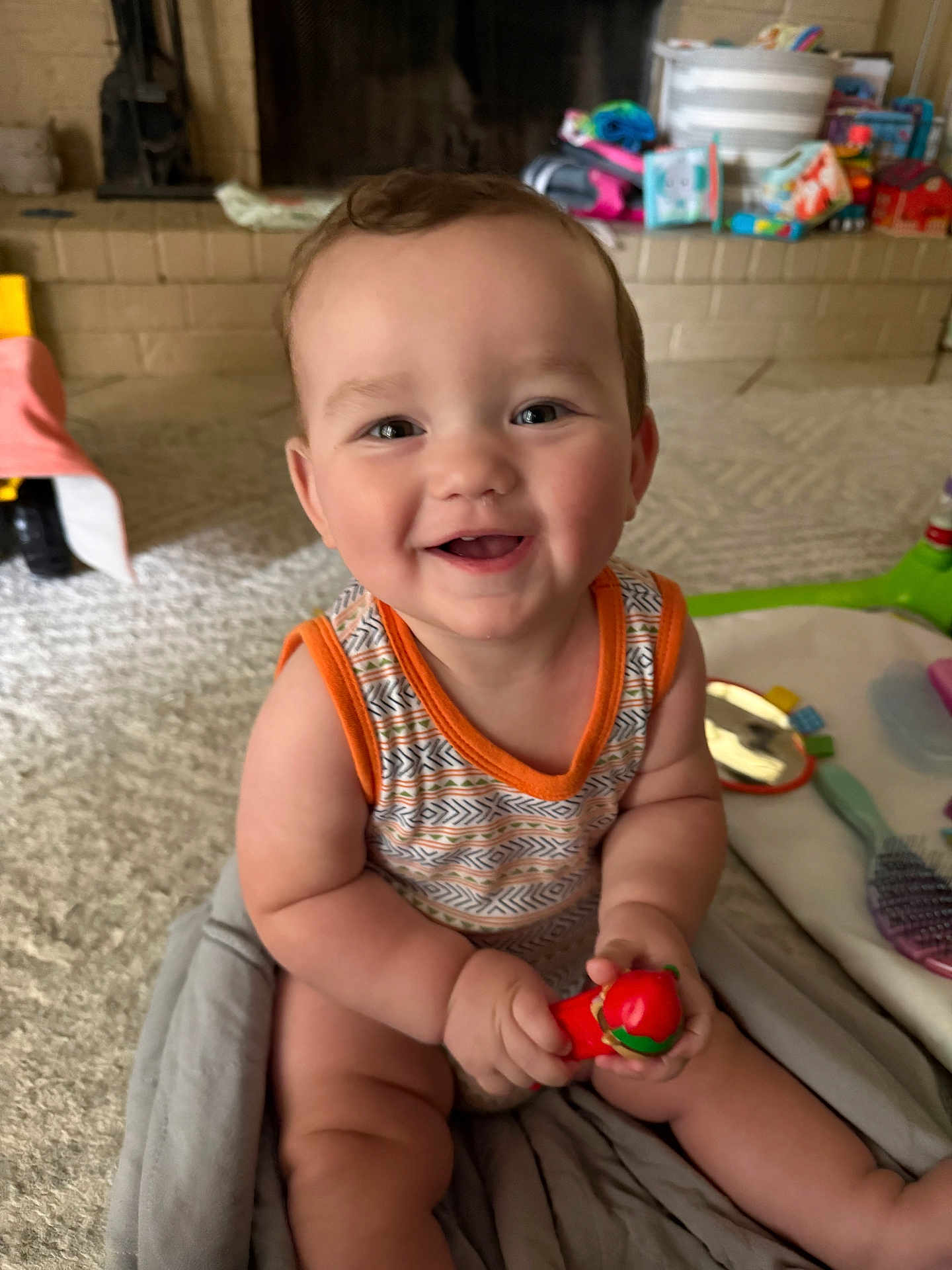 Henry joined the competition — help win amazing prizes! baby, smiling, toy, indoor, carpet, blanket, child, cute, happy, face, person, sitting, home, fireplace, colorful, plaything, infant, arm, leg, clothing