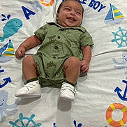 Ares joined the competition — help win amazing prizes! baby, infant, smiling, green_romper, white_shoes, blanket, nautical_theme, whale, octopus, anchor, lifebuoy, sailboat, baby_boy, cute, lying_down, happy, child, playful, patterned_clothing, indoor