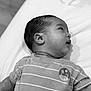 Ares joined the competition — help win amazing prizes! baby, infant, child, face, head, ear, shirt, striped_clothing, dinosaur_logo, lying_down, soft_surface, monochrome, black_and_white, portrait, cute, curious, young, close_up, skin, hair