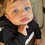Massimo is registered to the contest to win money with this photo: toddler, child, face, blue_eyes, black_hoodie, hand, car_seat, seat, portrait, cute, expression, indoor, baby, clothing, person, young_child, closeup, skin, hair, resting