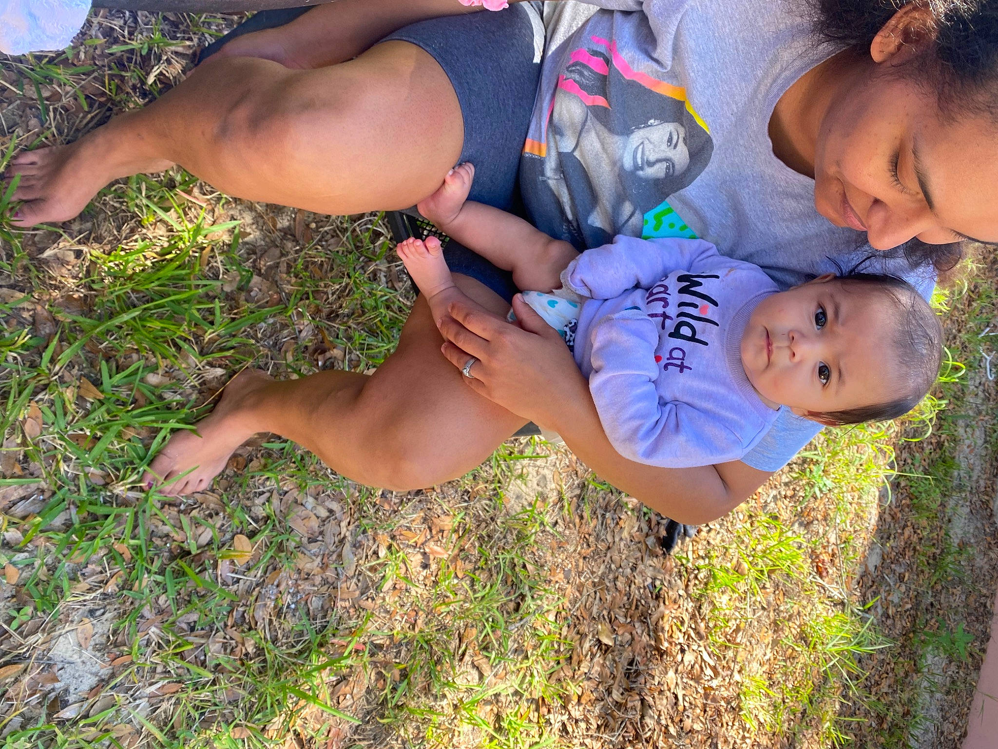 Olivia is registered to the contest to win money with this photo: baby, barefoot, calf, foot, fun, grass, grassland, happy, hat, human_leg, joy, knee, leisure, people_in_nature, person, plant, shorts, summer, thigh, toddler