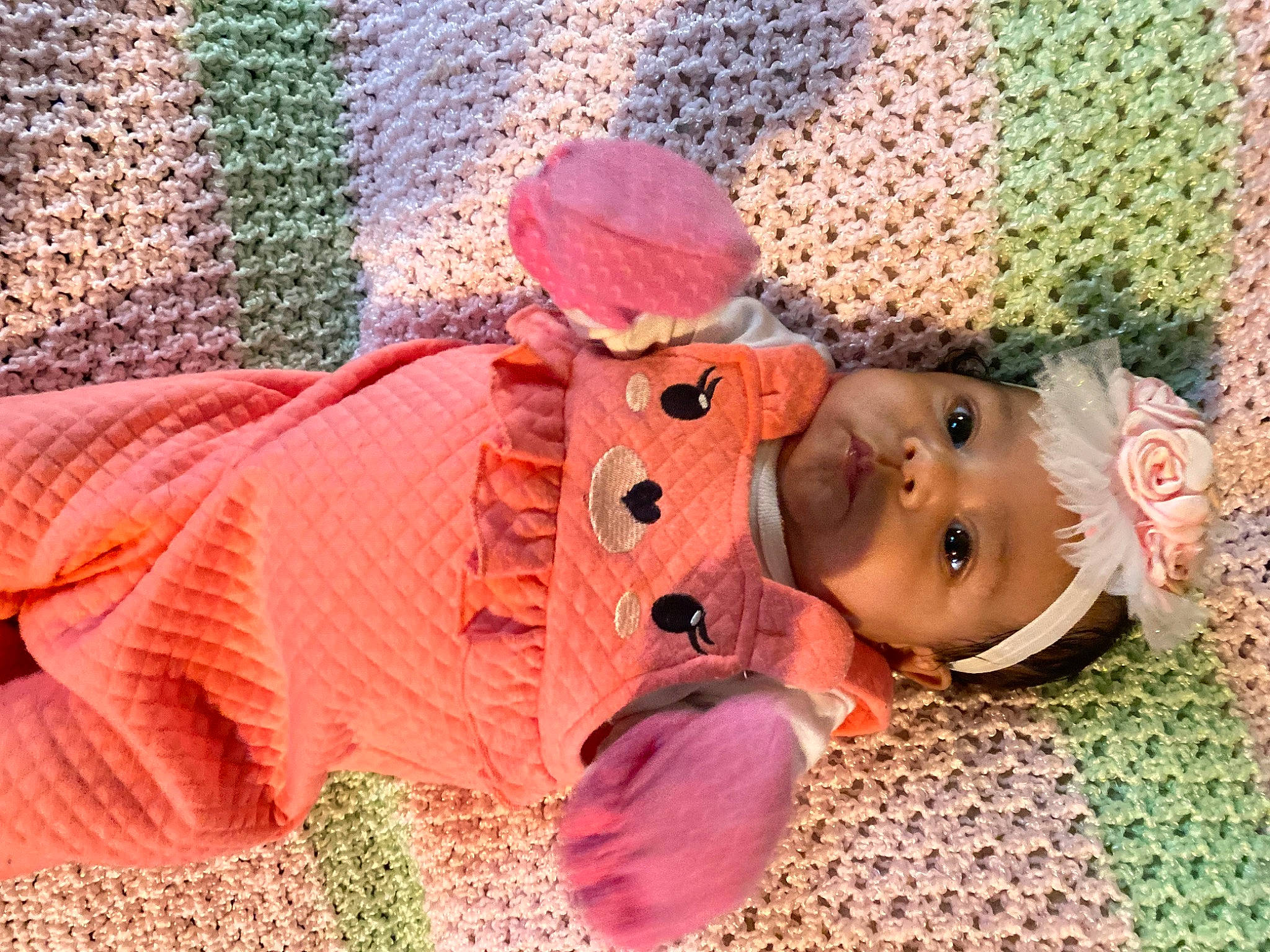 Olivia is registered to the contest to win money with this photo: baby, baby_toddler_clothing, cap, cheek, child, comfort, creative_arts, fashion_accessory, flooring, fun, headgear, headwear, linens, magenta, pattern, person, pink, toddler, toy, wood