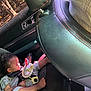 toddler, child, car_seat, toy, sleeping, inside, car, sunlight, window, seatbelt, clothing, foot, door, interior, nature, trees, peaceful, baby, resting, travel