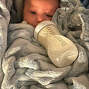 Ario joined the competition — help win amazing prizes! newborn, baby, infant, bottle, feeding, blanket, plush, gray, sleepy, face, eyes, portrait, indoors, cozy, bed, cuddled, textured_fabric, milk, resting, parenting