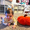 baby, infant, child, crawling, face, portrait, bow, hair, smiling, carpet, pumpkin, plush, nursery, baby_clothes, crib, shelf, toys, indoor, home, autumn