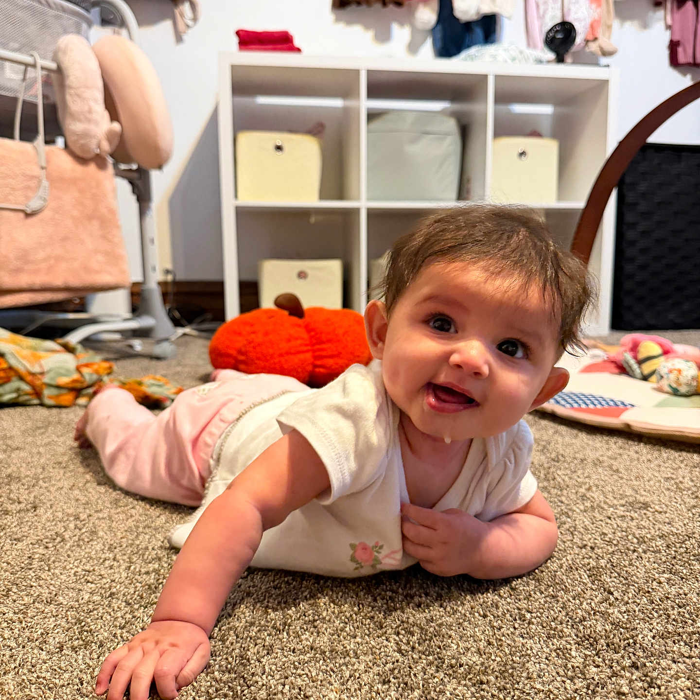 Julietta joined the competition — help win amazing prizes! baby, child, infant, smiling, crawling, floor, carpet, playroom, indoors, portrait, face, eyes, hands, clothing, dress, toys, stuffed_animal, shelves, wardrobe, nursery