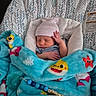 Bentley is registered to the contest to win money with this photo: newborn, baby, blanket, blue, hat, sleeping, infant, baby_seat, cozy, cute, striped_clothing, pacifier, toy, colorful, soft, indoor, resting, peaceful, child, comfort