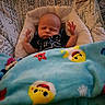Bentley is registered to the contest to win money with this photo: baby, blanket, blue, child, cozy, cushion, cute, face, furniture, hands, indoor, infant, pattern, person, resting, seat, sleeping, soft, toy, yellow
