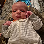 Bentley is registered to the contest to win money with this photo: baby, blanket, blue_blanket, carpet, closeup, cozy, expression, face, fist, floor, head, indoor, infant, newborn, onesie, patterned_blanket, person, sleepwear, striped_clothing, young