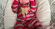 Bentley is registered to the contest to win money with this photo: baby, newborn, infant, onesie, striped_clothing, red_clothing, gray_clothing, baby_seat, cushion, patterned_background, face, head, hands, feet, sleepwear, cute, child, indoors, person, resting
