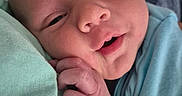 Bentley is registered to the contest to win money with this photo: baby, blue_clothing, child, close_up, cute, face, hand, indoors, infant, newborn, newborn_baby, peaceful, person, portrait, resting, skin, sleepy, smiling, soft_texture, toddler