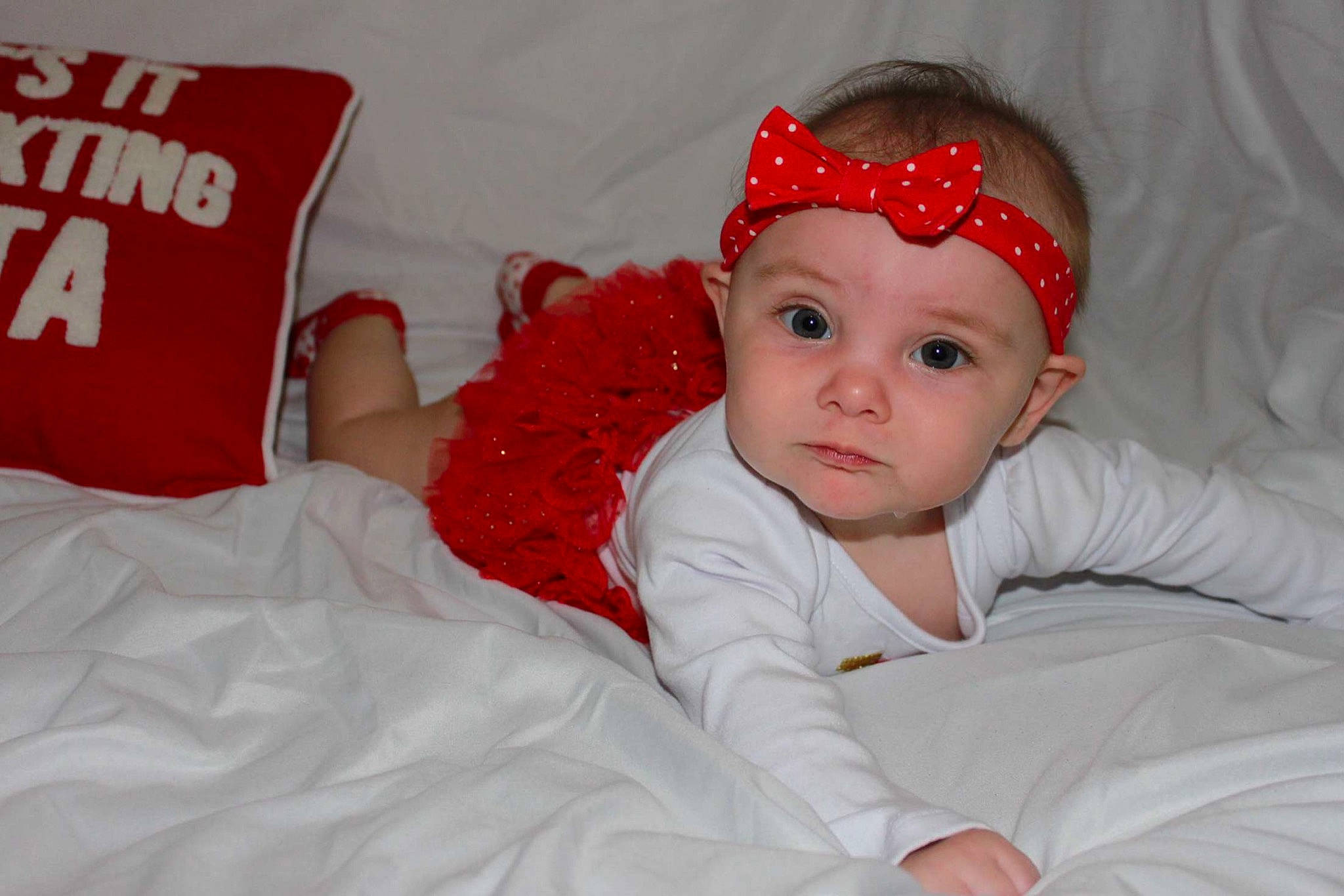 Claudia is registered to the contest to win money with this photo: baby, baby_toddler_clothing, child, fun, hair_accessory, headband, headgear, headpiece, person, red, skin, smile, toddler