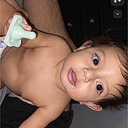 Maceo Noel Gonzales joined the competition — help win amazing prizes! baby, child, pacifier, skin, face, person, indoor, leg, hair, eyes, mouth, hand, torso, cabinet, furniture, human_body, expression, curious, infant, room