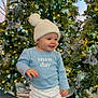 Sadie is registered to the contest to win money with this photo: blue_shirt, celebration, child, christmas_tree, cute, decorations, festive, happy, hat, holiday_lights, indoor, pink_shoes, pom_pom, seasonal, smiling, snow_day, standing, toddler, white_pants, winter_clothing