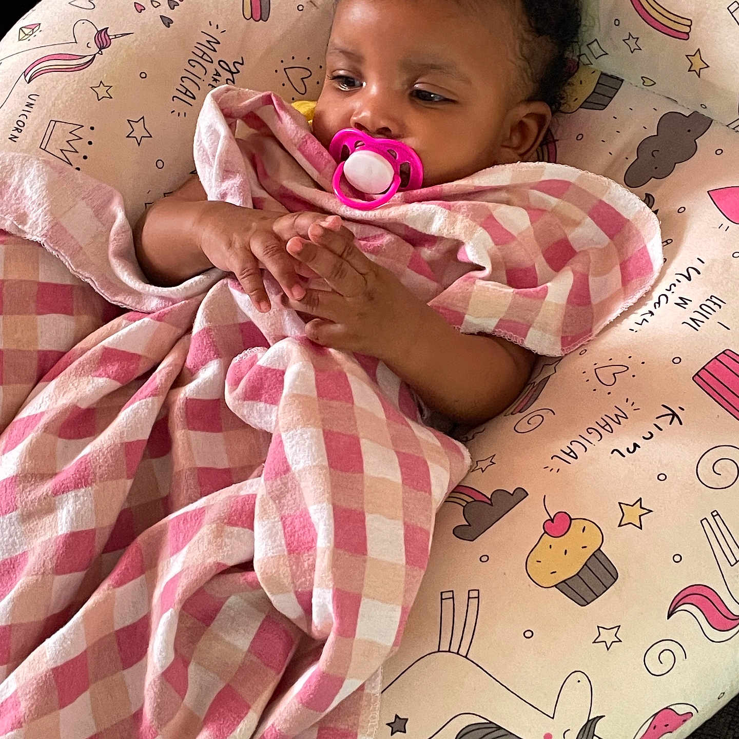 Mary Fatima joined the competition — help win amazing prizes! baby, blanket, checkered, child, comfort, curly_hair, cushion, cute, face, hand, indoor, infant, pacifier, pattern, pink, relaxing, resting, soft, toy, unicorn