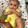 baby, big_eyes, bouncer_seat, child, closeup, colorful_ball, cute, hands, indoor, infant, legs, patterned_fabric, playtime, portrait, skin, smile, stuffed_toy, teether, toy_duck, yellow_onesie