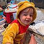 Declan is registered to the contest to win money with this photo: toddler, child, costume, winnie_the_pooh, smile, indoor, toy, playtime, carpet, foot, cute, happy, baby, hood, plush, red, yellow, person, crawling, home