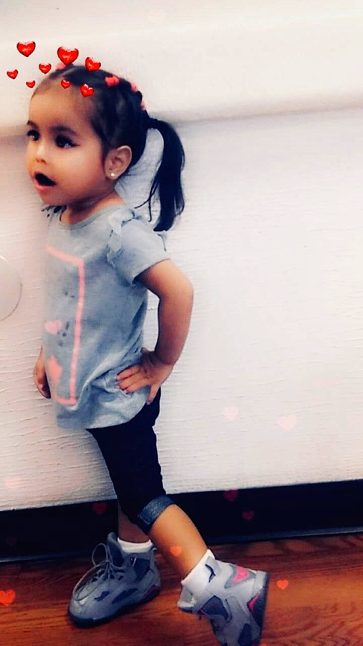 Aliyah is registered to the contest to win money with this photo: baby, beauty, cheek, child, child_model, cool, footwear, leg, lip, nose, outerwear, person, shoe, skin, sleeve, smile, sportswear, standing, t_shirt, toddler