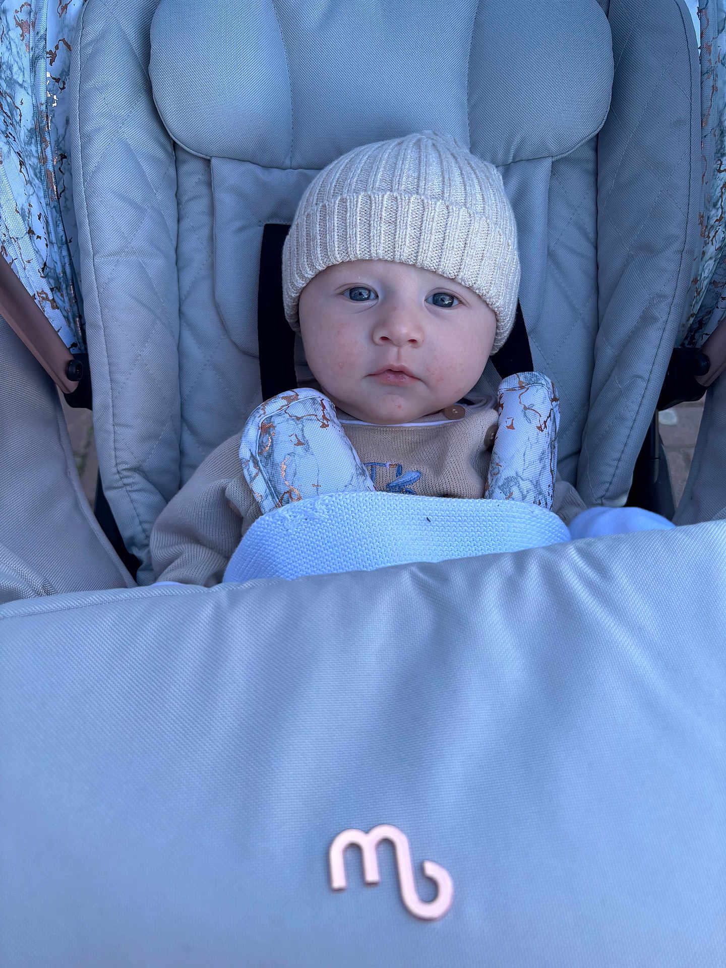 Rowan joined the competition — help win amazing prizes! baby, child, stroller, hat, knit_hat, blue_eyes, face, infant, outdoor, warm_clothing, padded_seat, blanket, person, cute, portrait, baby_clothes, bundle_up, seat_belt, baby_boy, infant_care