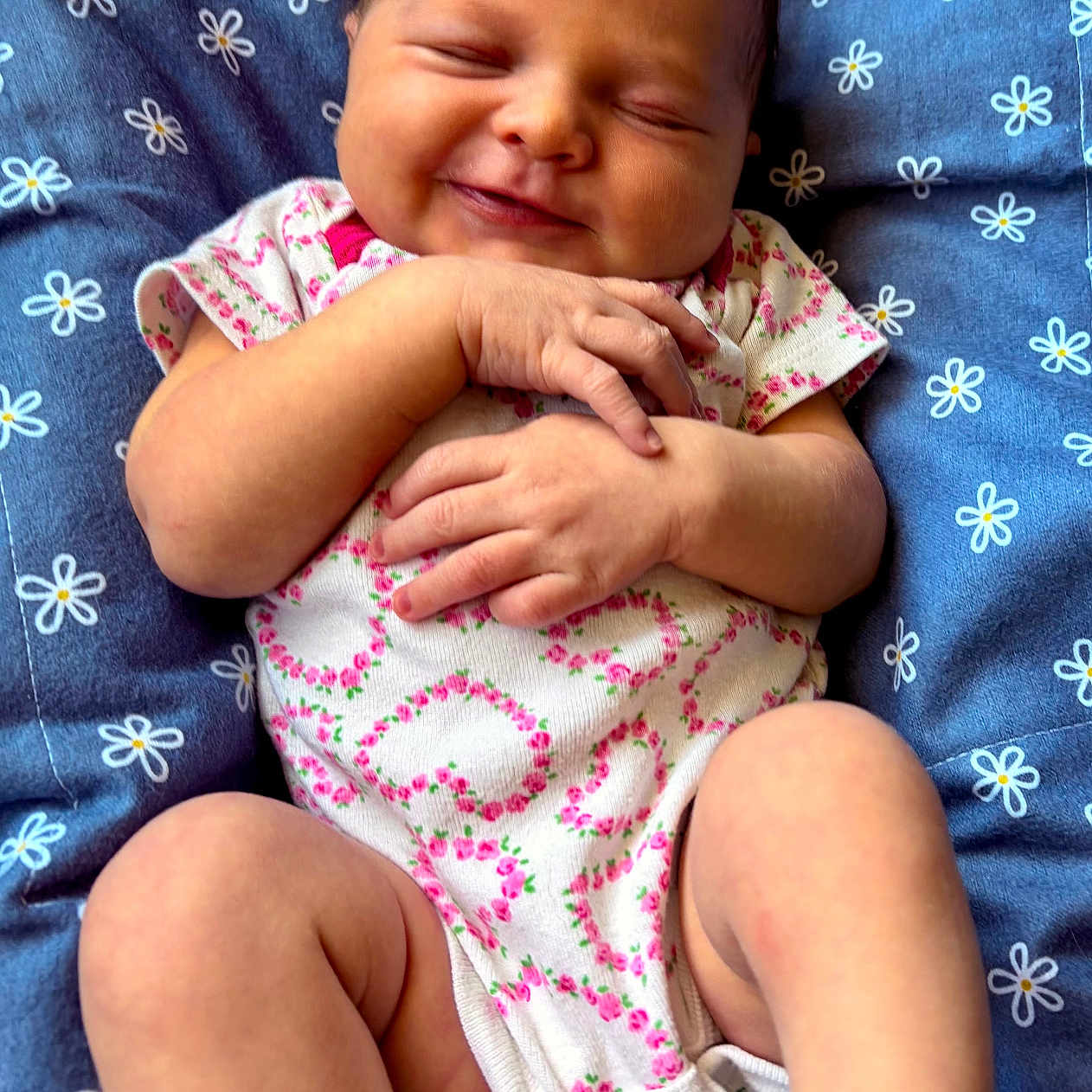 Phebe joined the competition — help win amazing prizes! baby, newborn, smiling, sleeping, infant, blanket, blue, floral_pattern, cute, peaceful, hands, legs, onesie, clothing, skin, portrait, resting, cozy, child, indoors