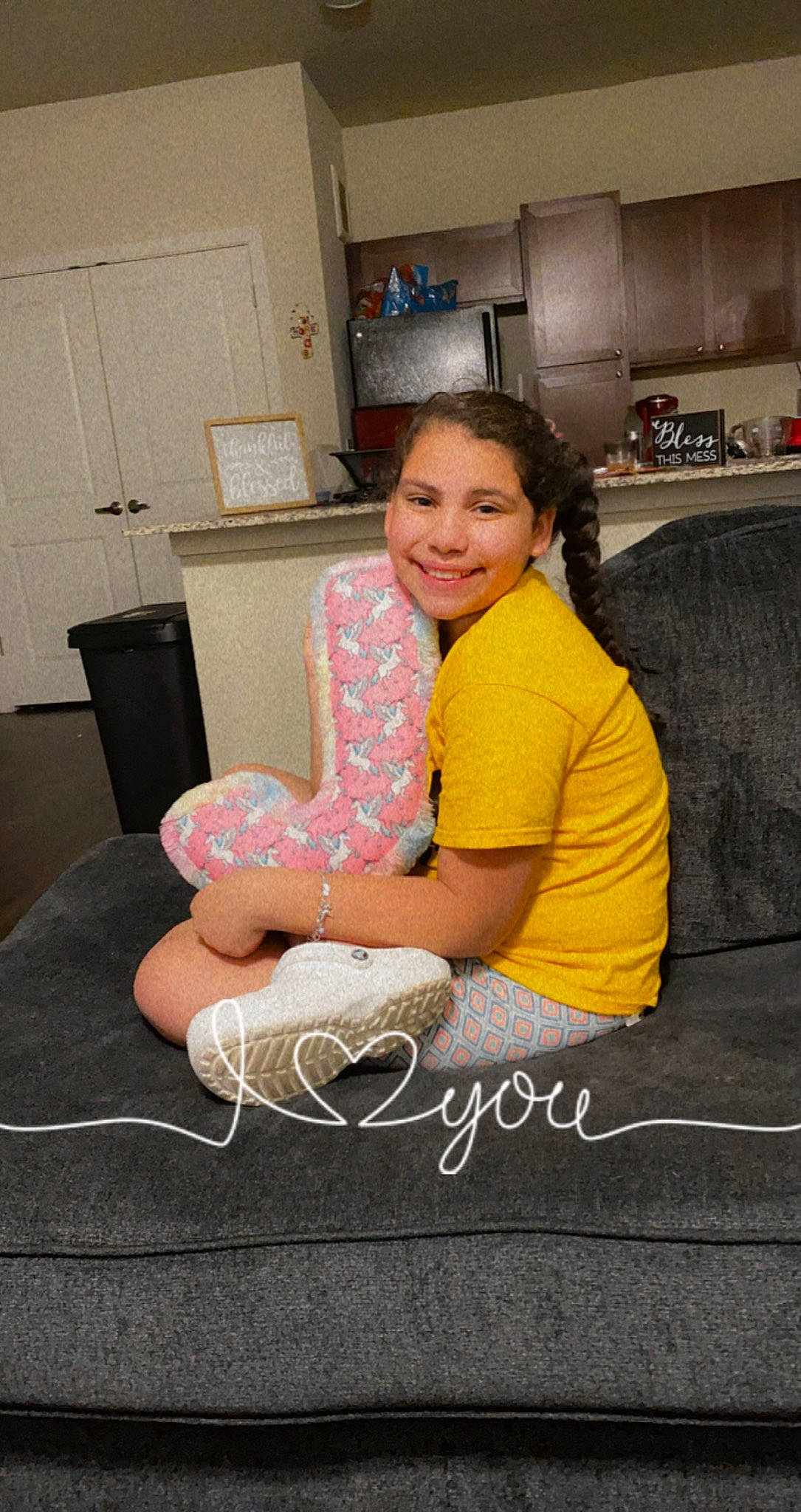 Jordin is registered to the contest to win money with this photo: cabinetry, comfort, couch, flash_photography, flooring, fun, happy, home_appliance, human_leg, joy, kitchen, kitchen_appliance, knee, lap, leisure, person, refrigerator, room, sitting, smile