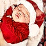 baby, sleeping, santa_hat, red_clothing, blanket, holiday, christmas, cute, infant, soft_texture, cozy, face, peaceful, wrapped, festive, newborn, portrait, child, head, cute_outfit