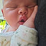 baby, sleeping, close_up, hand, face, infant, soft, patterned_clothing, peaceful, cheek, resting, indoors, newborn, child, cute, portrait, relaxed, skin, head, young