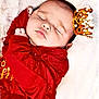 baby, sleeping, crown, red_clothing, fur, portrait, infant, peaceful, closeup, soft_texture, headwear, cute, resting, child, newborn, indoors, cozy, adorable, face, person