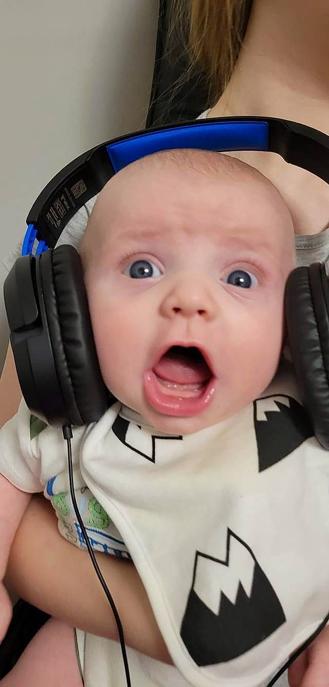 Grayson is registered to the contest to win money with this photo: audio_equipment, baby, baby_toddler_clothing, blue, cap, cheek, child, chin, cool, eye, eyebrow, eyelash, finger, fun, happy, hearing, nose, person, photograph, surprise