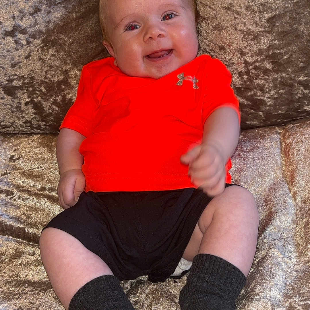 Archie joined the competition — help win amazing prizes! baby, bodypart, clothing, couch, face, finger, footwear, furniture, head, hosiery, pants, person, photography, portrait, rock, shoe, shorts, sitting, sock, t_shirt