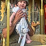Liam a rejoint le concours — aidez-le/la à gagner de superbes lots ! baby, child, adult, hand, bucket_hat, carousel, carousel_horse, toy, stuffed_animal, bunny_toy, smiling, happy, outdoor, amusement_ride, colorful, vintage, portrait, face, clothing, seat