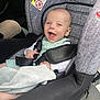 baby, car_seat, smiling, child, infant, blanket, seatbelt, car_interior, happy, sitting, clothing, person, cute, young_child, safety, seat, head, face, baby_clothes, toddler