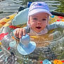 baby, child, colorful, cute, fish_pattern, float, happy, hat, inflatable_ring, nature, outdoor, playful, recreation, summer, sunlight, swimming, swimwear, toy, water, water_sports