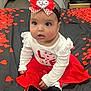 baby, child, girl, headband, heart, love, bed, bedroom, red_skirt, white_top, sitting, indoor, cute, petals, decoration, clothing, footwear, expression, portrait, innocence
