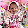 Magnolia is registered to the contest to win money with this photo: baby, infant, smile, hood, bow, minnie_mouse, pink, hearts, pattern, bouncer_seat, warning_label, polka_dots, hand, legs, eyes, clothing, cute, toy_pattern, seat_strap, happy