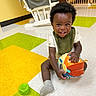 toddler, child, smiling, toy, ball, floor, colorful, indoor, play, sitting, sock, bib, happy, person, floor_tile, furniture, baby, cute, childcare, young