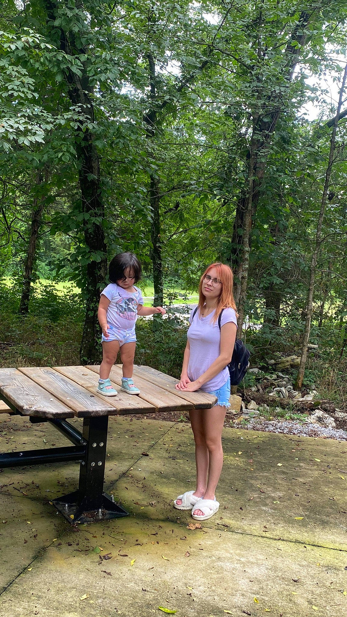 Anais is registered to the contest to win money with this photo: bench, forest, fun, grass, joy, landscape, leg, leisure, natural_landscape, outdoor_bench, outdoor_furniture, people_in_nature, person, picnic_table, plant, recreation, shorts, summer, table, tree