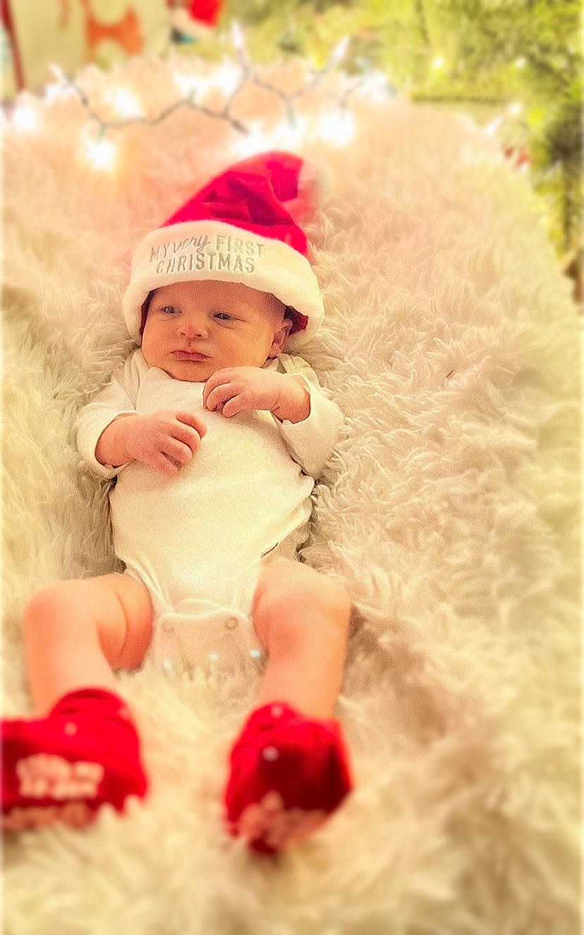 Asher joined the competition — help win amazing prizes! baby, baby_toddler_clothing, cap, child, christmas, dress, event, fictional_character, fun, fur, grass, happy, headwear, holiday, magenta, peach, people_in_nature, person, pink, sitting